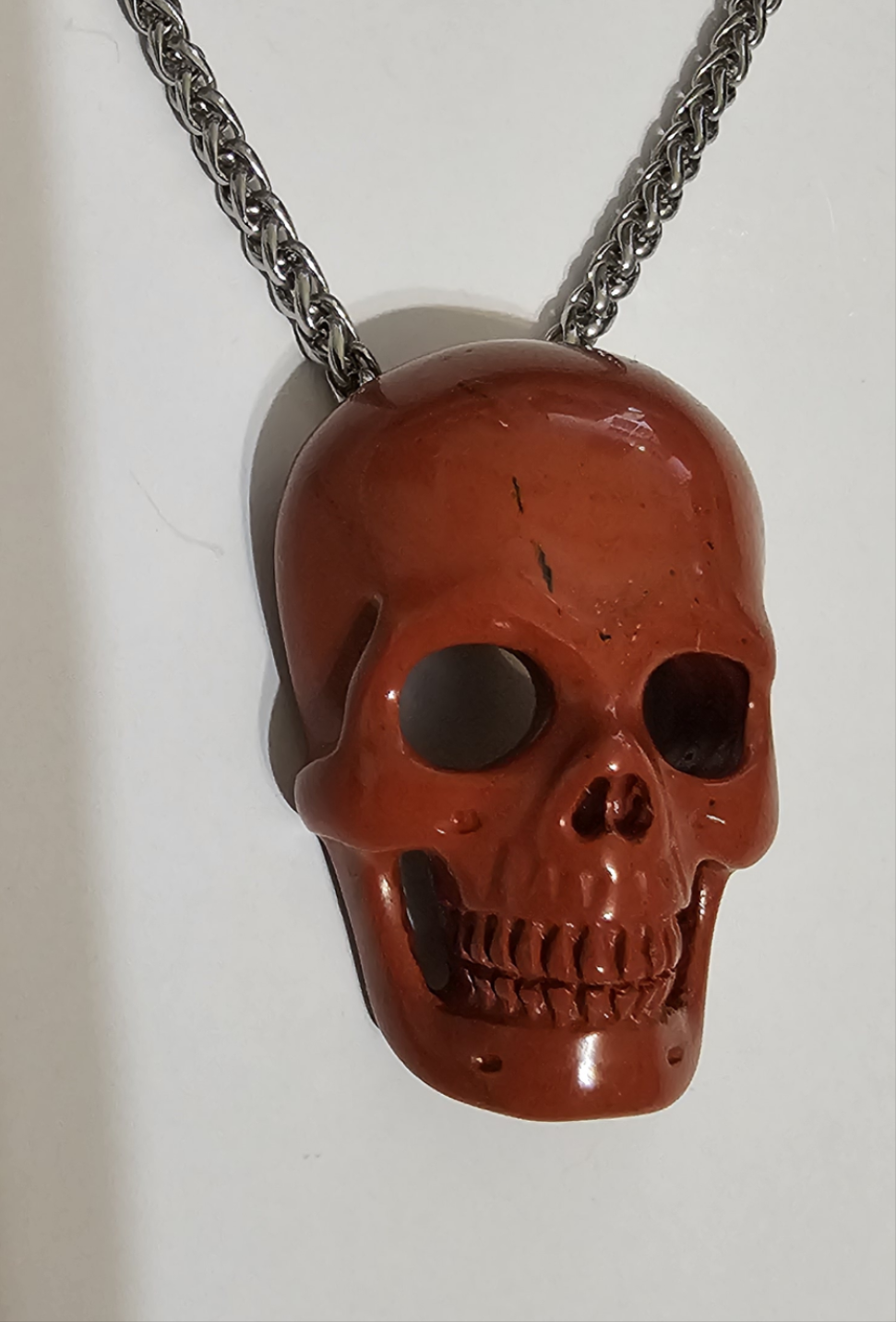 Red Jasper, Skullis, hand carved skull with invisible bale & stainless steel chain.